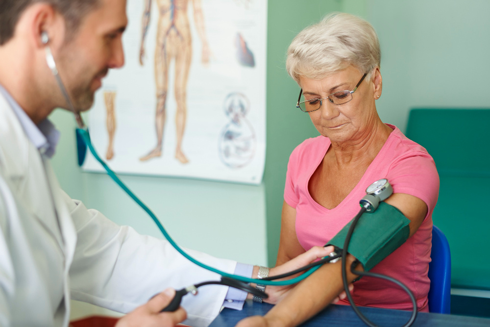 Doctor checking a woman's blood pressure in a doctor's office Doctor checking a woman's blood pressure in a doctor's office