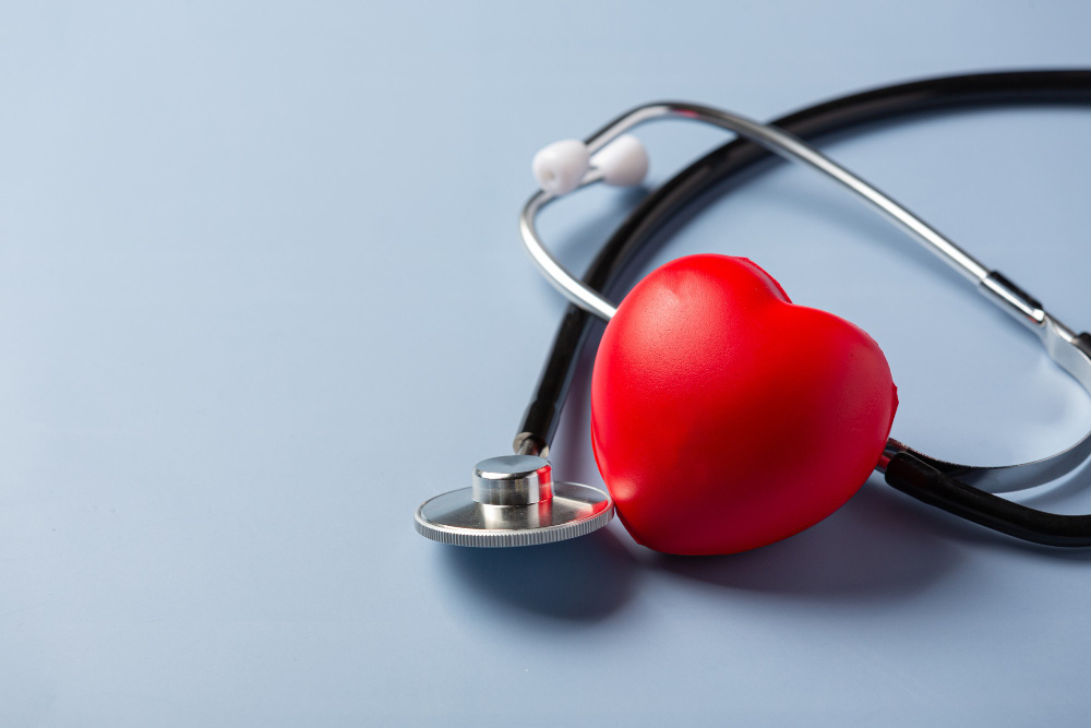 Stethoscope around a red heart stress ball