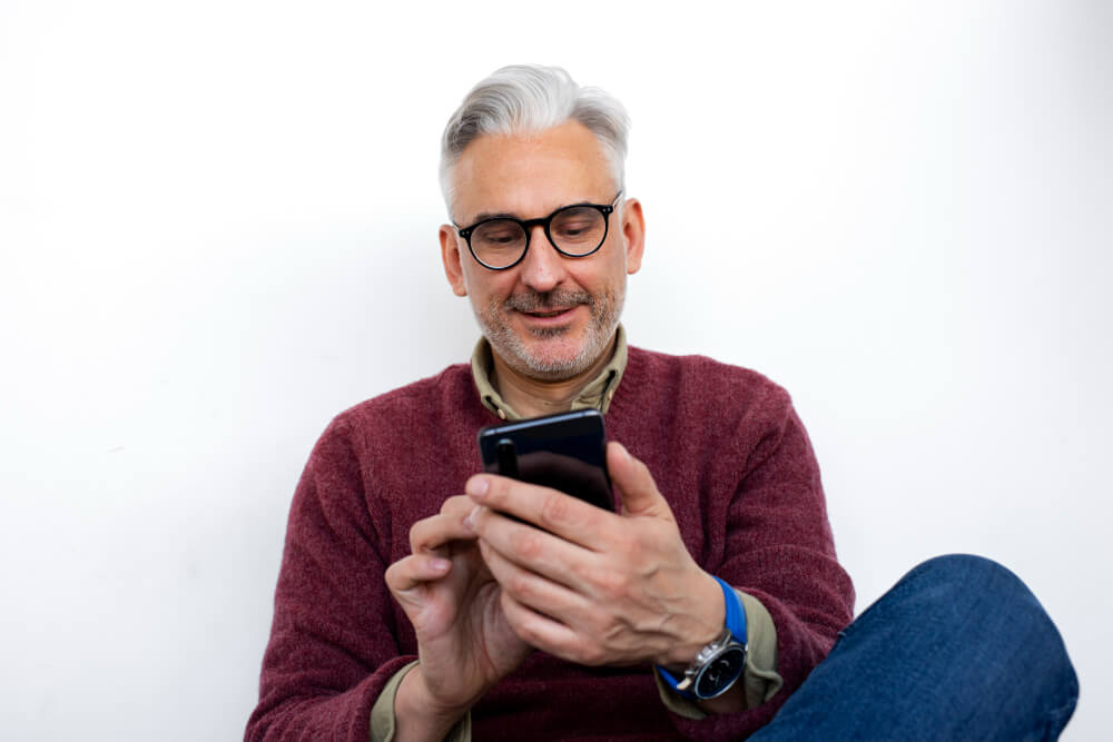 grey haired man using phone grey haired man using phone