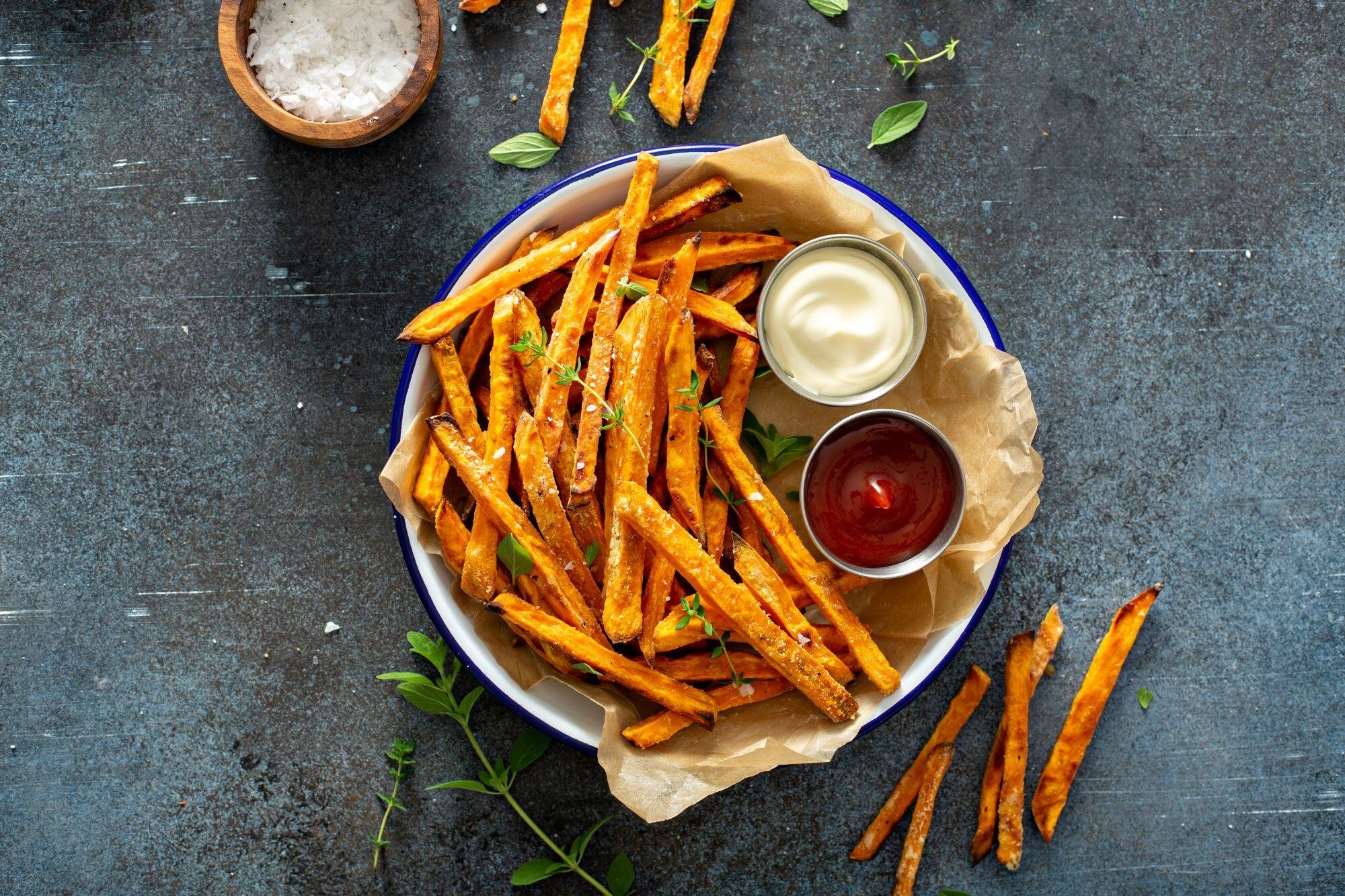 Sweet potato fries with mayo and ketchup, homemade roasted in the oven reduced