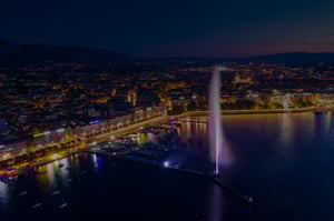 Aerial-night-view-of-Geneva-city-water-fountain-in-Switzerland