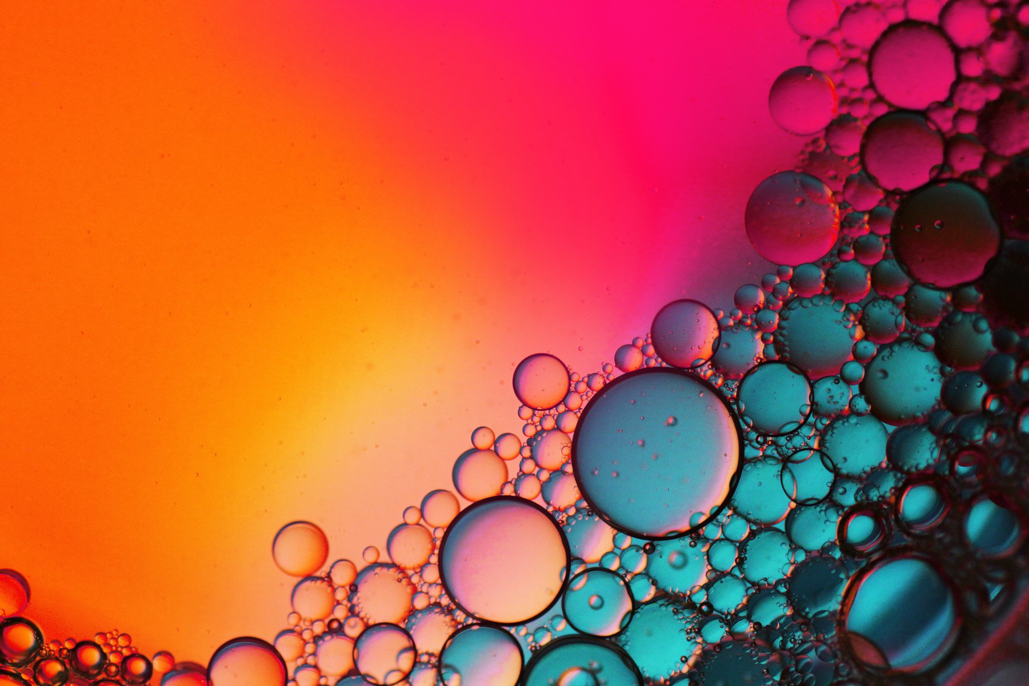 Macro-shot-of-water-abstract-in-bright-neon-colors-pink-orange-and-teal