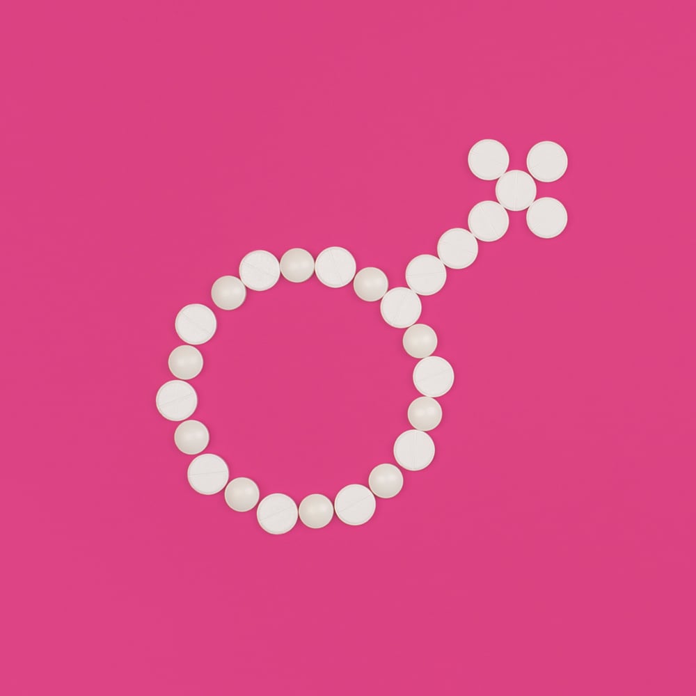 Womens-health-pharmaceutical-clinical-trial-concept-white-pills-on-pink-background-female-symbol