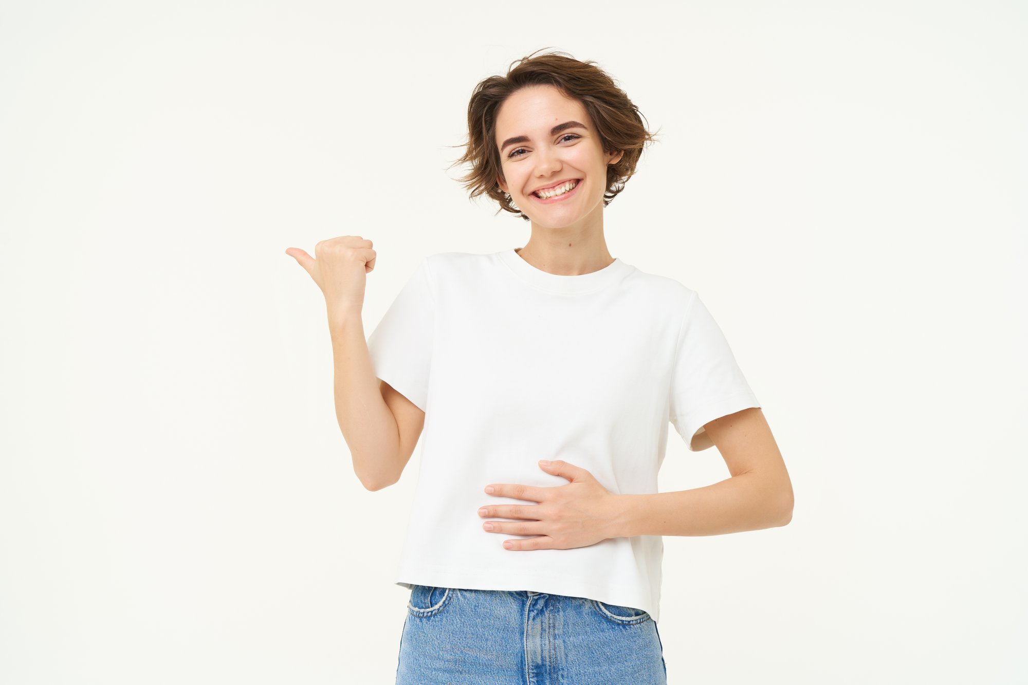 happy-healthy-young-woman-pointing-left-showing-advertisement-touching-her-belly-feeling-better (1)