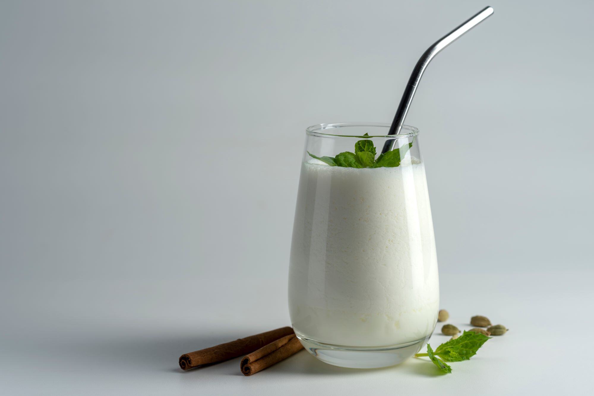 lassi, lassie - indian yogurt drink with spice on white background reduced