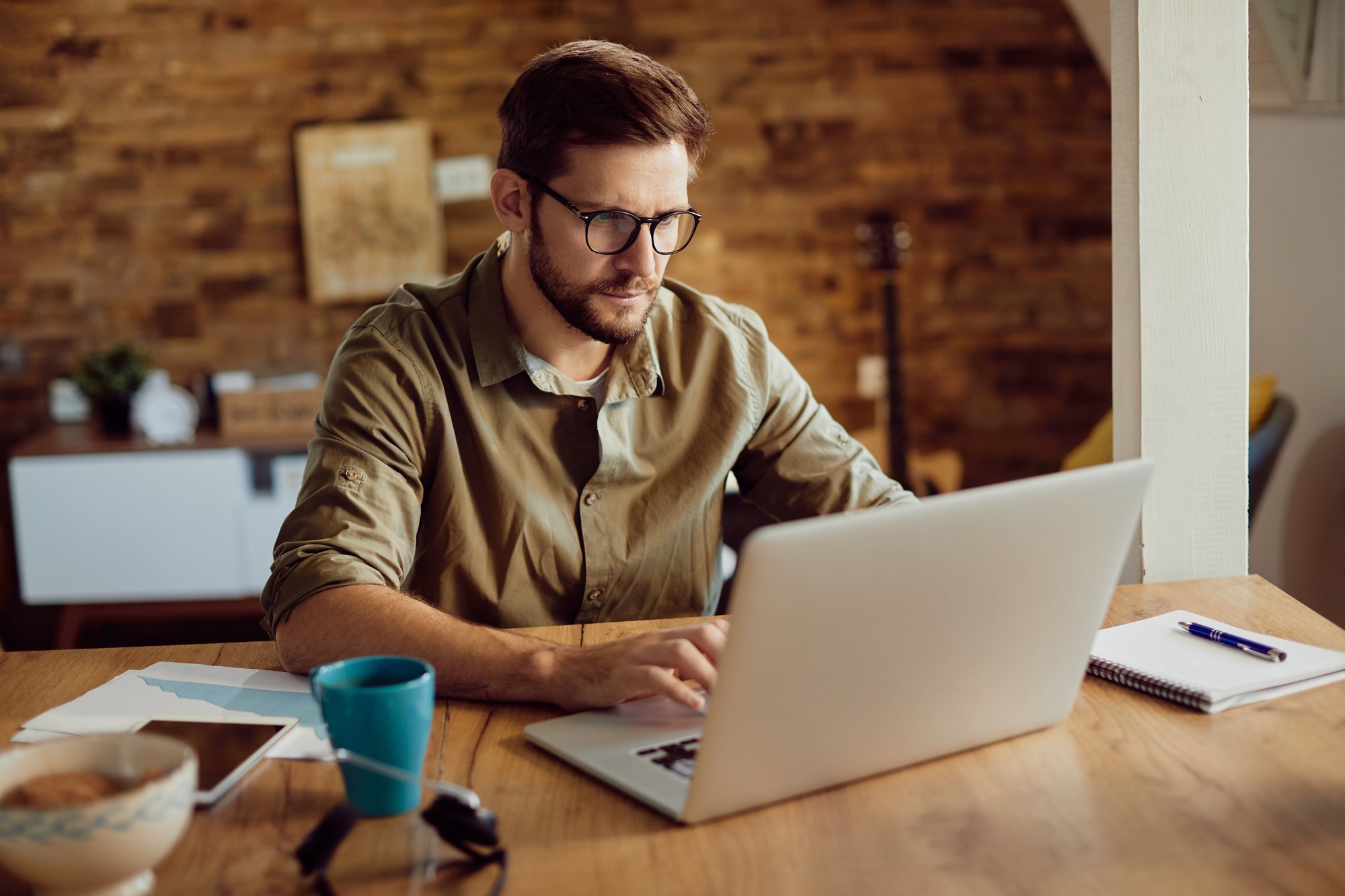 male-entrepreneur-working-computer-home