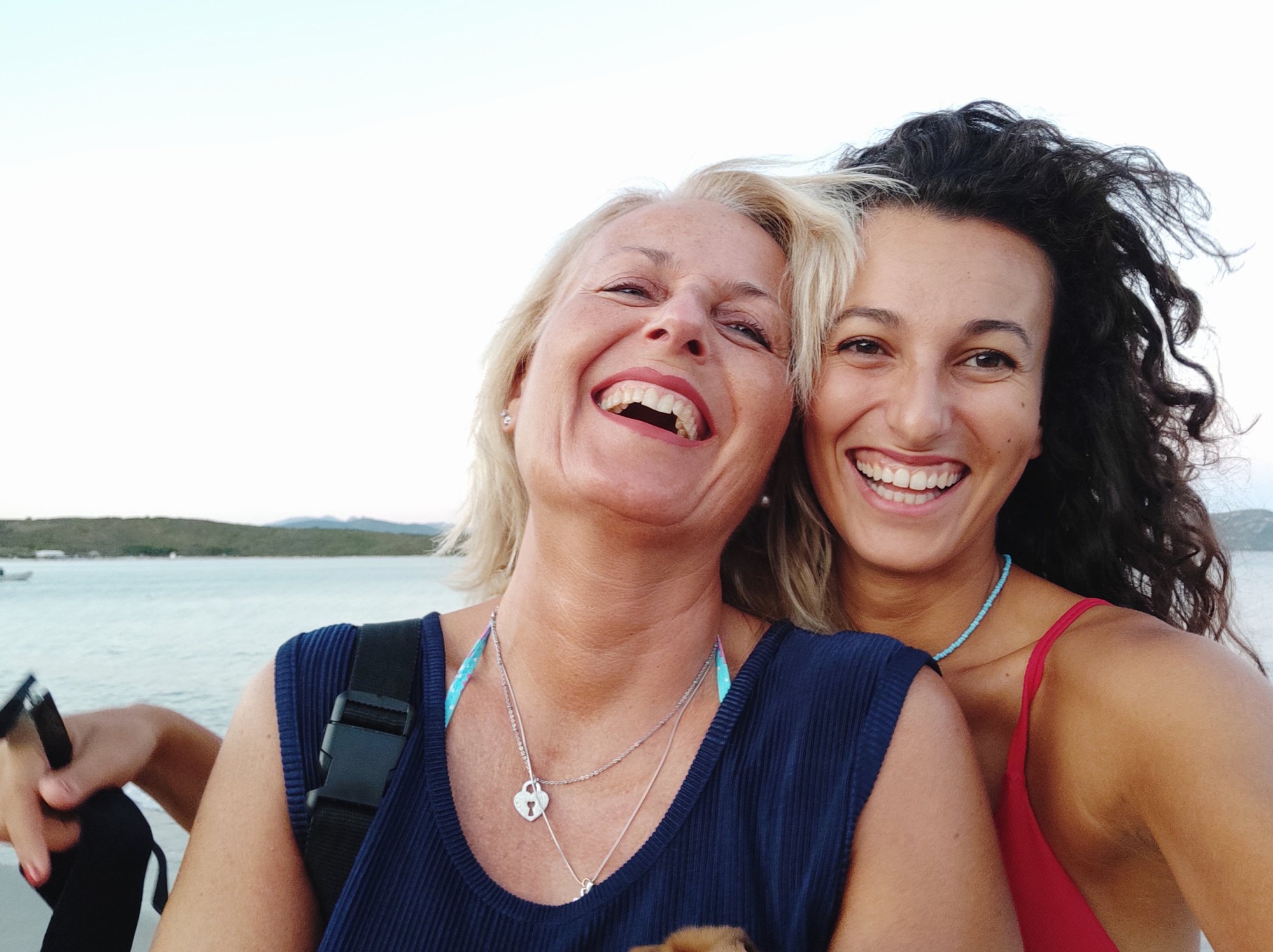 portrait-smiling-woman-her-daughter-against-sky