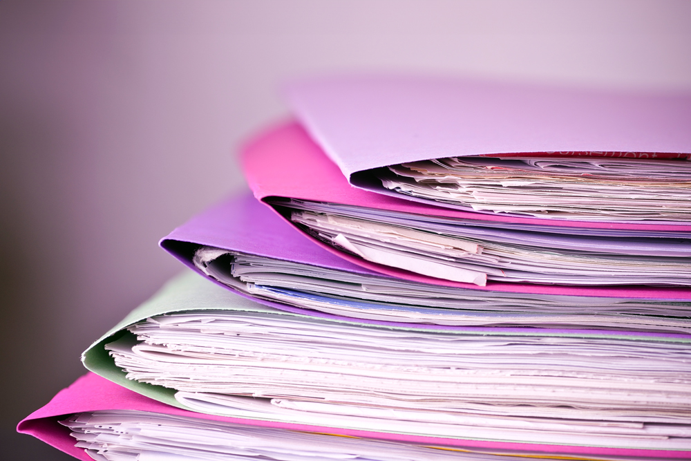 Pink-and-purple-dossiers-document-submission-concept-regulatory-compliance